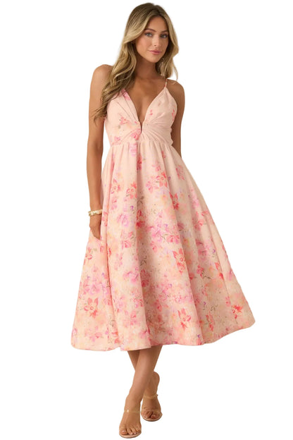 Woman wearing a pink floral dress against a beige background