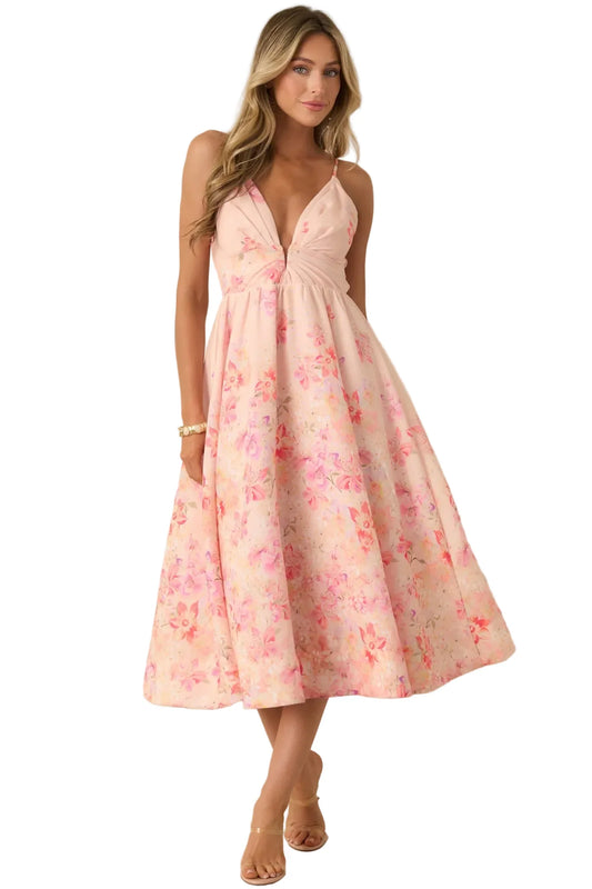 Woman wearing a pink floral dress against a beige background