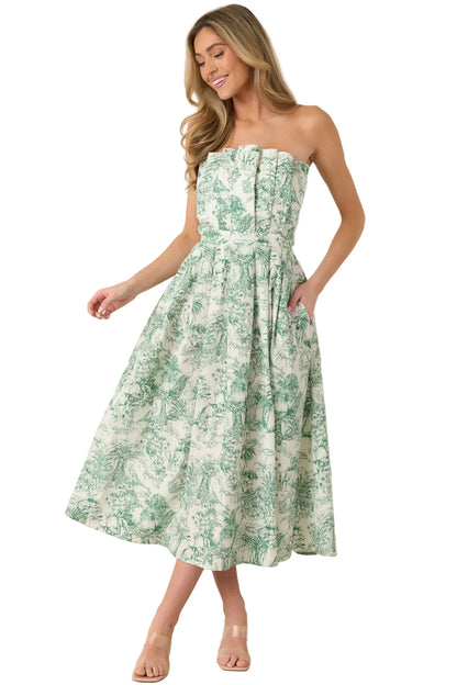 Woman wearing a strapless green floral dress against a beige background