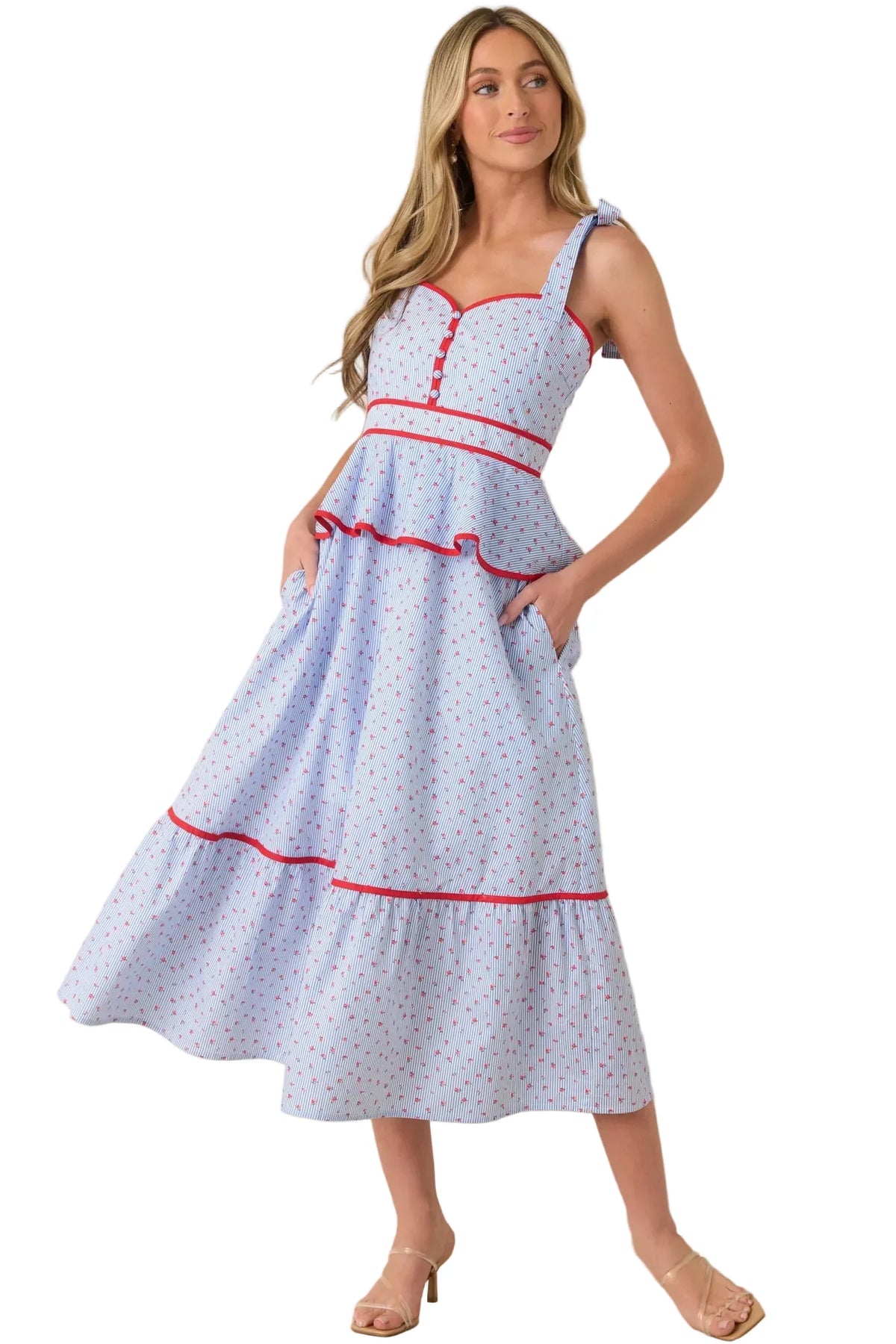 Woman wearing a light blue dress with red accents on a beige background