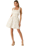 Woman wearing a floral dress against a beige background