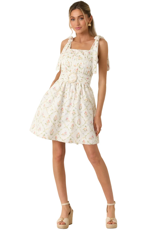 Woman wearing a floral dress against a beige background