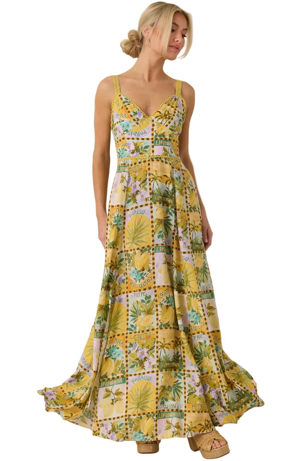 Woman wearing a yellow floral dress against a beige background