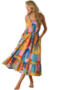 Woman wearing a colorful patchwork dress against a beige background