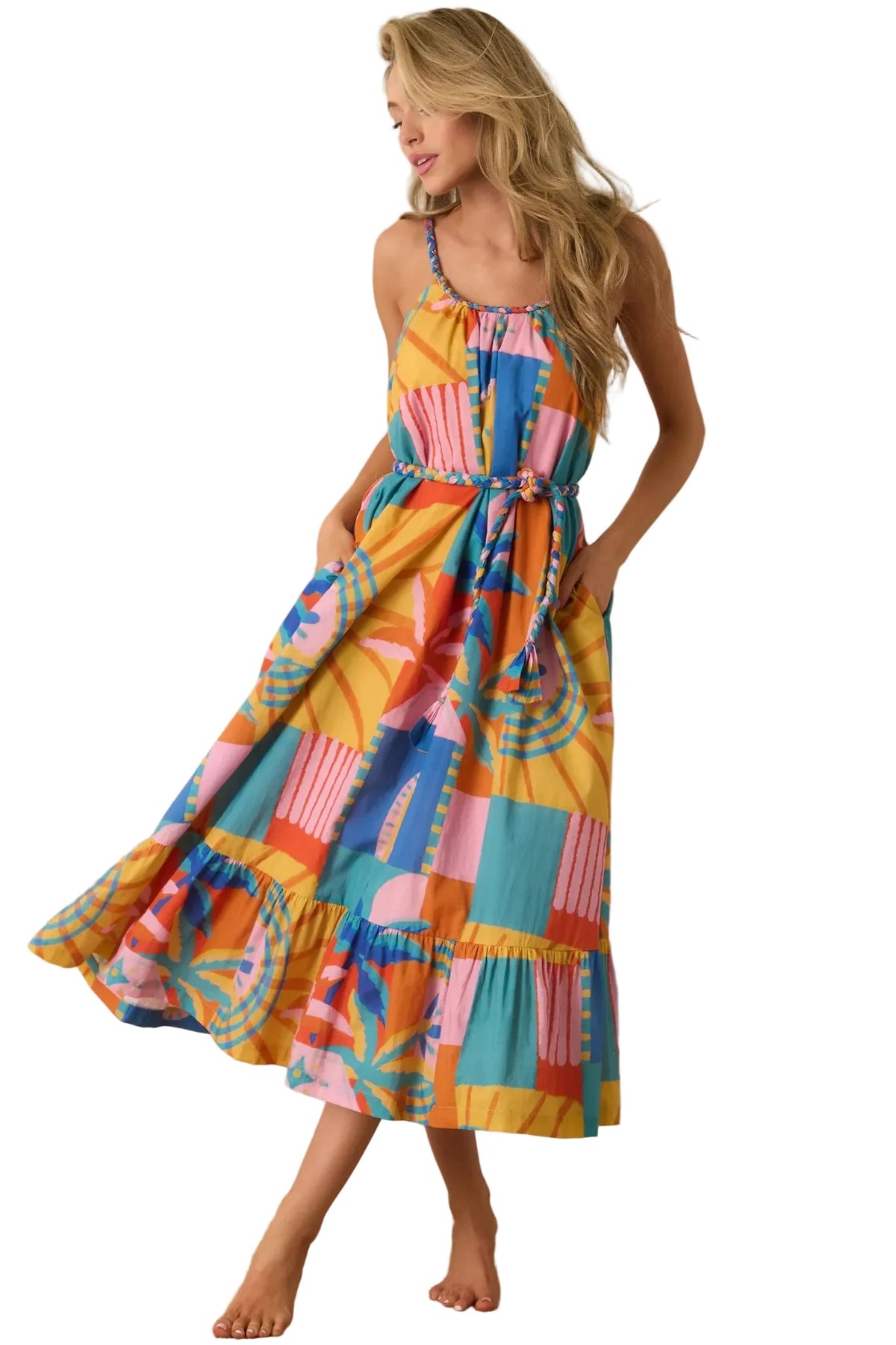 Woman wearing a colorful patchwork dress against a beige background