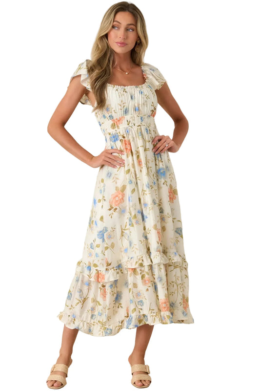 Woman wearing a floral dress against a plain background