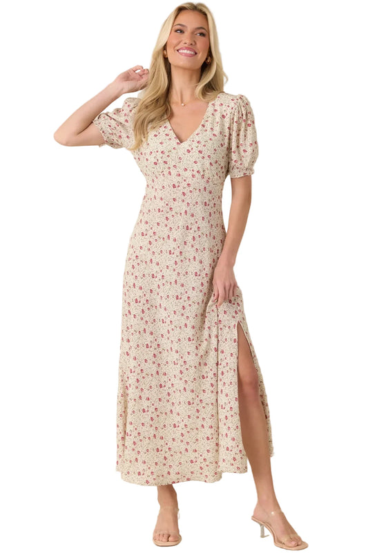 Woman wearing a floral dress with a beige background